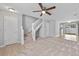 Inviting living room featuring plush carpet, a ceiling fan, and staircase access at 3563 Chestnut Dr. # 3563, Myrtle Beach, SC 29577