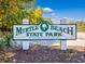 Entrance to Myrtle Beach State Park, featuring a sign and lush greenery, inviting visitors to explore nature at 3563 Chestnut Dr. # 3563, Myrtle Beach, SC 29577
