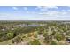 Serene aerial view of the home in a lush, green neighborhood with a scenic lake nearby at 3731 Spruce Dr., Myrtle Beach, SC 29577
