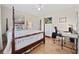 Spacious bedroom with hardwood floors, four-poster bed, and bright natural light at 3731 Spruce Dr., Myrtle Beach, SC 29577