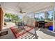 Covered outdoor patio features grill, outdoor furniture, and view to street at 3731 Spruce Dr., Myrtle Beach, SC 29577