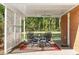 Covered patio with stylish furniture, fan, and peaceful backyard view at 3731 Spruce Dr., Myrtle Beach, SC 29577