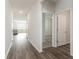 Hallway leading to the living room and bedroom, with hardwood floors and white walls at 376 Black Pearl Way, Myrtle Beach, SC 29588