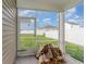 Covered porch features a screened enclosure with views of backyard and a pile of firewood at 376 Black Pearl Way, Myrtle Beach, SC 29588