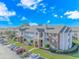 Exterior view of a multi-Gathering building with balconies, brick accents, and lush landscaping at 3795 Hitchcock Way # 617, Myrtle Beach, SC 29577
