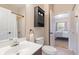 Cozy bathroom with a dark wood cabinet, vanity and an open doorway to the main bedroom at 3943 Gladiola Ct. # 202, Myrtle Beach, SC 29588