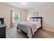 Bedroom with large window, plush carpet, and neutral paint at 3943 Gladiola Ct. # 202, Myrtle Beach, SC 29588