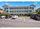 Three-story condo building featuring multi-level balconies and well-maintained landscaping at 3943 Gladiola Ct. # 202, Myrtle Beach, SC 29588
