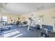 Well-equipped fitness center with treadmills, ellipticals, and natural light, promoting a healthy lifestyle at 3943 Gladiola Ct. # 202, Myrtle Beach, SC 29588