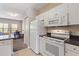 Kitchen with sleek countertops, white cabinets, and modern white appliances at 3943 Gladiola Ct. # 202, Myrtle Beach, SC 29588