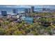 Aerial view of resort-style property, showcasing a lake, a pool, and lush landscaping with ocean views at 410 Melrose Pl. # 110, Myrtle Beach, SC 29572