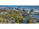Aerial view featuring a lake, a pool, and lush landscaping with ocean views at 410 Melrose Pl. # 110, Myrtle Beach, SC 29572