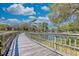 Scenic boardwalk winding alongside a tranquil lake and lush trees in a vibrant community at 410 Melrose Pl. # 110, Myrtle Beach, SC 29572
