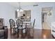 Dining area adjacent to kitchen with hardwood floors and view into the kitchen at 410 Melrose Pl. # 110, Myrtle Beach, SC 29572