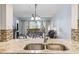 Kitchen with granite counters, stainless steel appliances, and open layout to dining area at 410 Melrose Pl. # 110, Myrtle Beach, SC 29572