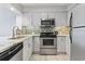 Updated kitchen featuring stainless steel appliances and modern cabinets at 410 Melrose Pl. # 110, Myrtle Beach, SC 29572