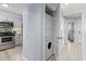 Modern kitchen featuring stainless steel appliances and a convenient laundry closet with a stackable washer and dryer at 410 Melrose Pl. # 110, Myrtle Beach, SC 29572