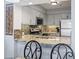 Kitchen with stainless steel appliances and granite counters, open to the dining area at 410 Melrose Pl. # 110, Myrtle Beach, SC 29572