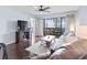 Open concept living room featuring modern furniture, dark floors, and balcony access at 410 Melrose Pl. # 110, Myrtle Beach, SC 29572