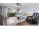Bright living room featuring a balcony, comfortable seating, and modern ceiling fan at 410 Melrose Pl. # 110, Myrtle Beach, SC 29572