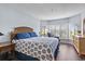 Primary bedroom with lots of windows and comfortable furniture at 410 Melrose Pl. # 110, Myrtle Beach, SC 29572