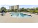 Inviting outdoor pool with comfortable lounge chairs, umbrellas, and stunning views of nearby high-rise buildings at 410 Melrose Pl. # 110, Myrtle Beach, SC 29572