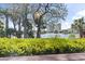 Scenic waterfront view featuring lush trees, greenery, and towering buildings in the distance against a blue sky at 410 Melrose Pl. # 110, Myrtle Beach, SC 29572