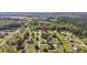 Wide aerial view of a home in a rural wooded neighborhood surrounded by mature trees and landscaping at 4100 Hagwood Circle, Conway, SC 29526