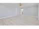 Large, bright bedroom showing doors to the bathroom and kitchen, light wood-look floors and white trim at 4100 Hagwood Circle, Conway, SC 29526