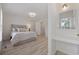 Bright bedroom with neutral colors, wood floors, vanity, and natural light at 4100 Hagwood Circle, Conway, SC 29526