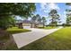 Charming brick home with a spacious driveway and well-manicured lawn in a serene, tree-lined setting at 4100 Hagwood Circle, Conway, SC 29526