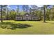 Charming brick home with lush lawn, mature trees, and manicured shrubbery at 4100 Hagwood Circle, Conway, SC 29526