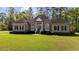 Charming brick home with lush lawn, mature trees, and manicured shrubbery at 4100 Hagwood Circle, Conway, SC 29526