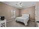 This bedroom offers a large window for natural light, ceiling fan and neutral carpet at 411 Mahogany Dr. # 202, Murrells Inlet, SC 29576