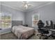 Bedroom includes 2 windows for natural light, ceiling fan and accent wall decor at 411 Mahogany Dr. # 202, Murrells Inlet, SC 29576
