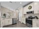 Well-lit kitchen featuring modern appliances, granite countertops, and ample cabinet space at 411 Mahogany Dr. # 202, Murrells Inlet, SC 29576
