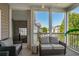 Cozy screened porch with comfortable seating and views of the neighborhood at 411 Mahogany Dr. # 202, Murrells Inlet, SC 29576
