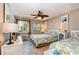 Cozy bedroom featuring two beds, coastal decor, soft lighting, and tiled floors for a comfortable retreat at 4201 N Ocean Blvd. # 2H, North Myrtle Beach, SC 29582