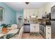 Bright kitchen with white cabinetry, stainless steel appliances, granite countertops, and adjacent dining area at 4201 N Ocean Blvd. # 2H, North Myrtle Beach, SC 29582