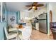 Cozy kitchen featuring stainless steel appliances, a dining table with seating, and ample cabinet space at 4201 N Ocean Blvd. # 2H, North Myrtle Beach, SC 29582
