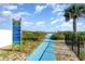 Picturesque beach walkway with lush greenery and a clear view of the ocean at 4201 N Ocean Blvd. # 2H, North Myrtle Beach, SC 29582