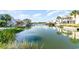 Picturesque waterfront homes with private docks, surrounded by serene water and lush greenery at 4201 N Ocean Blvd. # 2H, North Myrtle Beach, SC 29582
