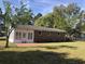 This home features a brick patio and white sunroom perfect for indoor/outdoor entertaining at 4204 Peachtree Ln., Myrtle Beach, SC 29588