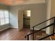 Spacious bedroom features wood floors, a walk-in closet, and stairs to the next floor at 4204 Peachtree Ln., Myrtle Beach, SC 29588