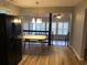 Dining room features sleek appliances, a modern table set, and open concept layout at 4204 Peachtree Ln., Myrtle Beach, SC 29588