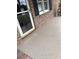 This home has a painted speckled concrete front porch, a storm door, and brick facade at 4204 Peachtree Ln., Myrtle Beach, SC 29588