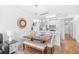 Dining area adjacent to kitchen with seating for six, wood-look floors, and modern lighting at 4518 N Planatation Harbour Dr. # G-17, Little River, SC 29566