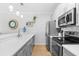 Bright kitchen features updated appliances, grey cabinets, and a pass-through to living area at 4518 N Planatation Harbour Dr. # G-17, Little River, SC 29566