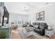Cozy living room features tray ceiling, neutral walls, ceiling fan, and comfortable leather furniture at 4518 N Planatation Harbour Dr. # G-17, Little River, SC 29566
