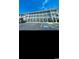 Exterior view of the building with a parking lot, blue sky, white balconies and stairs on the side of the property at 4669 Wild Iris Dr. # 22-2O2, Myrtle Beach, SC 29577
